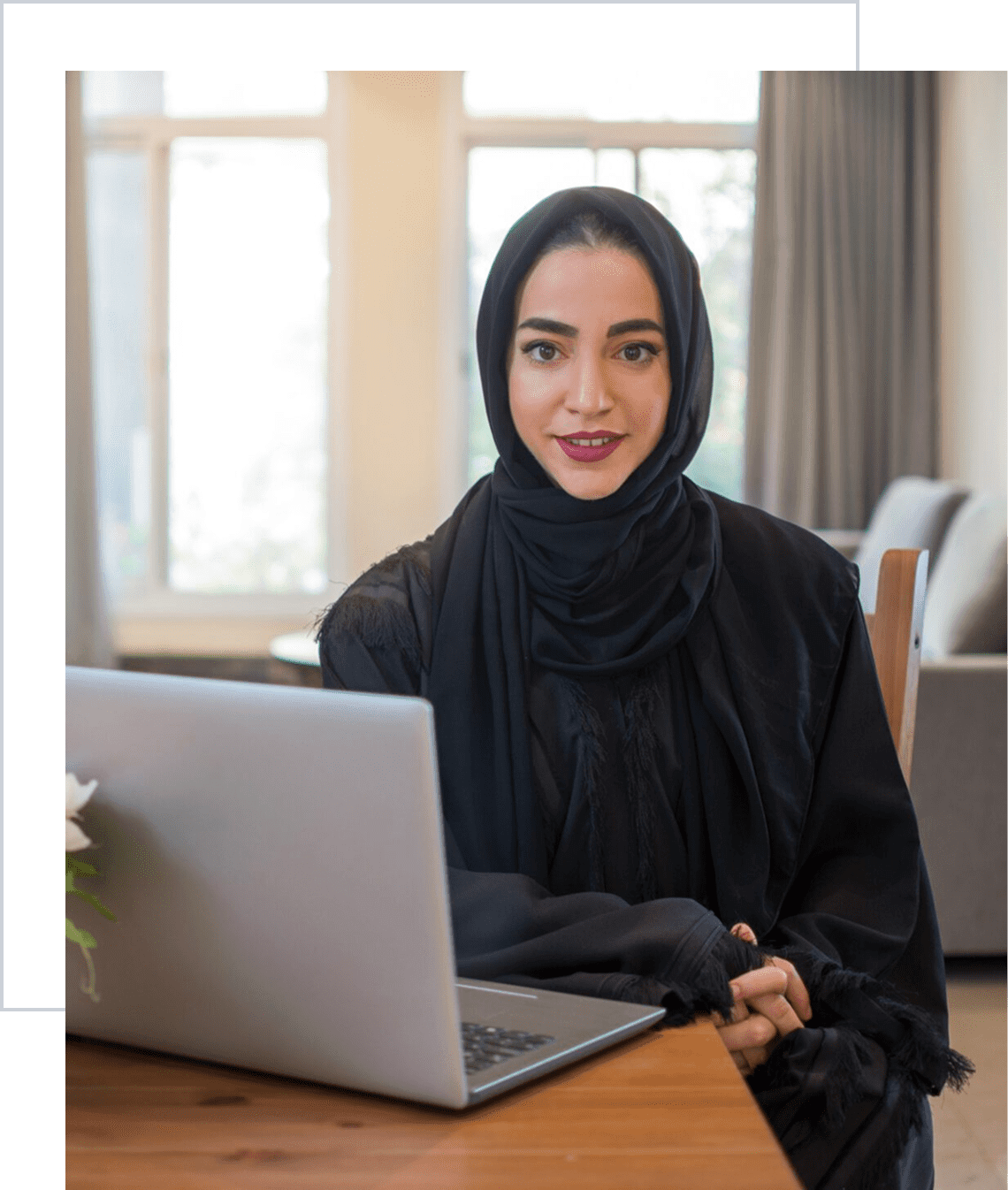 Professional woman smiling with laptop