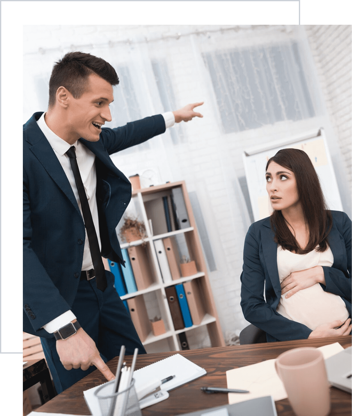 Man pointing angrily at pregnant woman
