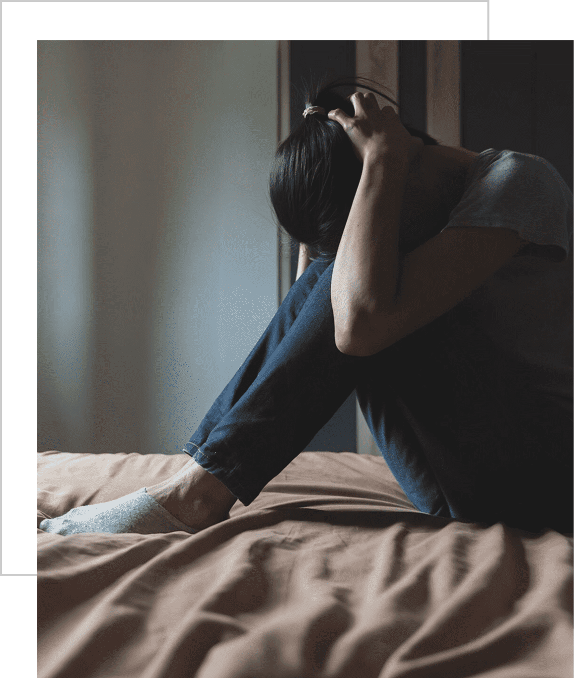 Contemplative person sitting in dimly lit room