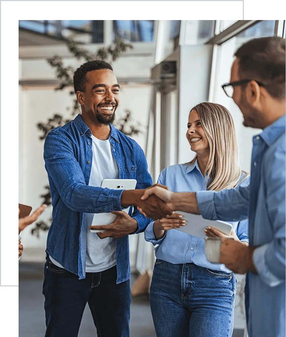 Colleagues smiling while shaking hands